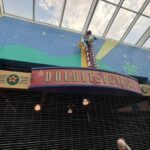 The entrance to the "Double Feature" store at a Disney resort, featuring a closed metal gate and a marquee with Donald Duck perched on top.