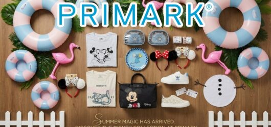 Flat lay of Primark's Disney Summer collection featuring Mickey Mouse bags, clothing, Ratatouille accessories, Minnie ears, and pool floats.