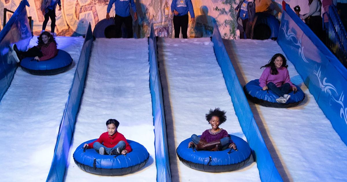 Riders sliding down the Snow Flow Mountain indoor ice tubing hill at Gaylord Palms