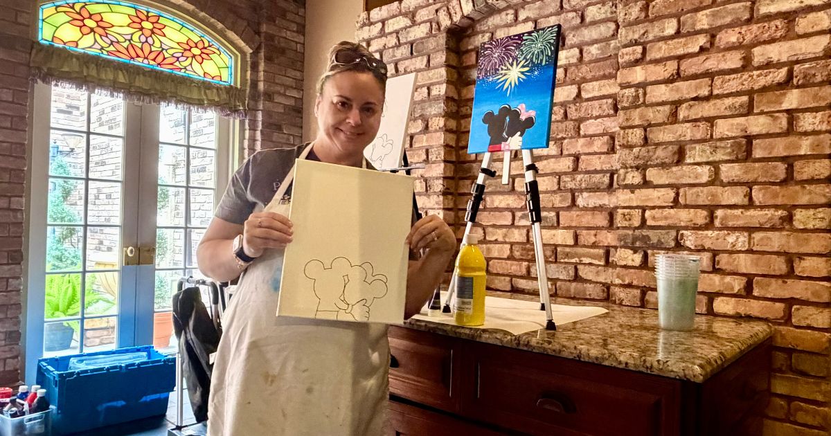 Participant painting at an easel during the Painting on de Bayou art class