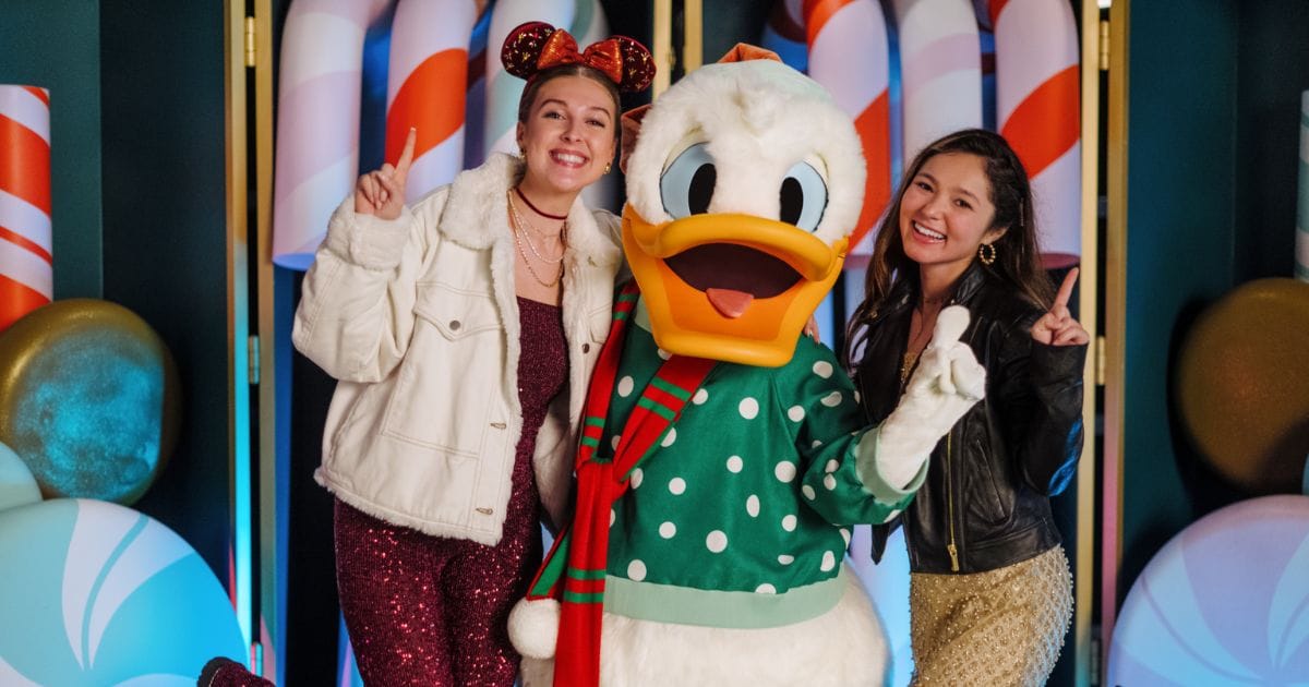 Guests using Disney PhotoPass Service at Jollywood Nights