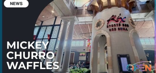 Review: Chicken and Mickey Churro Waffles at Rix Sports Bar 15 Exterior entrance of Rix Sports Bar and Grill at Disney's Coronado Springs Resort featuring tall stone pillars and Mickey Churro Waffles news banner.