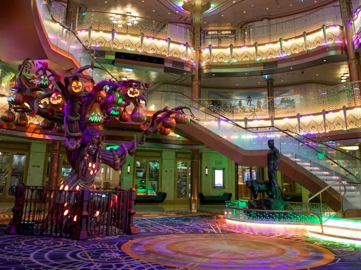 Disney Destiny Grand Hall decorated for Halloween on the High Seas featuring the illuminated pumpkin tree and Black Panther statue