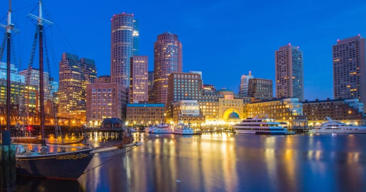 Disney Wish 5-Night Canada & New England Cruise 2027 Booking Guide 6 The illuminated Boston waterfront at dusk, a featured port stop on the Disney Wish Northeast itinerary