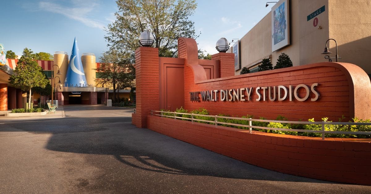 Red brick entrance monument with The Walt Disney Studios lettering in front of the Sorcerer Hat building at Disney's Hollywood Studios