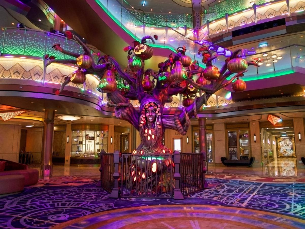 Front view of the glowing Halloween Pumpkin Tree in the center of the Disney Destiny Grand Hall