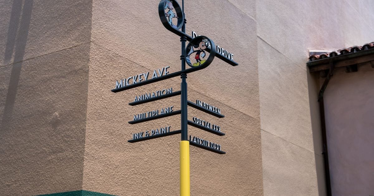 Burbank studio-style directional street signpost at Disney's Hollywood Studios pointing toward Animation, Multiplane, Ink and Paint, and Layout Dept
