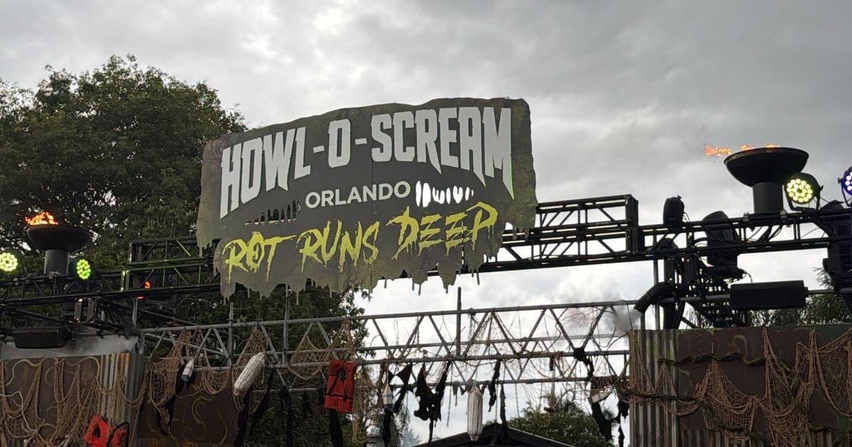 Distressed outdoor entrance truss featuring the SeaWorld Howl-O-Scream Orlando banner and dripping green text reading Rot Runs Deep, flanked by flame torches