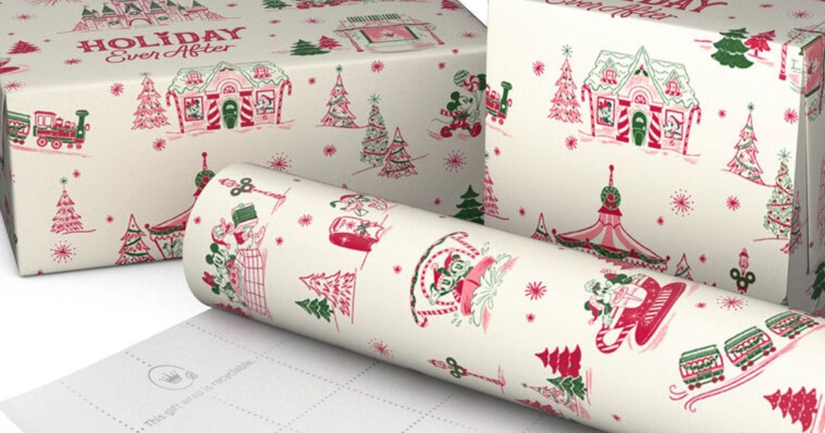 Rolls and wrapped boxes of Hallmark x Disney Holiday Ever After gift wrap with red and green sketches of Mickey Minnie and Disney Parks icons