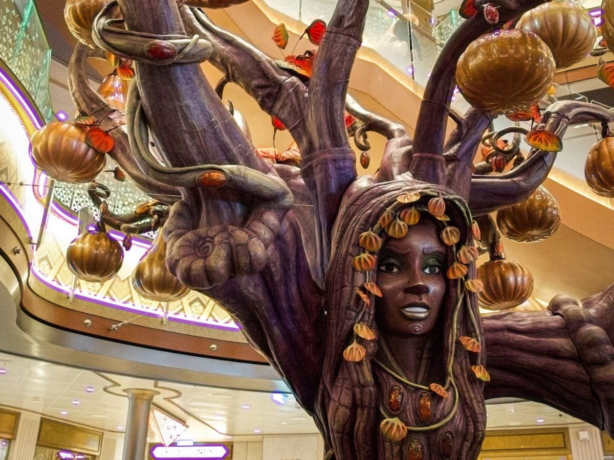 Detailed view of the Disney Destiny Halloween tree showing Solara the sculpted face and hanging pumpkin branches