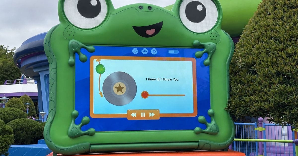 Lilypad digital screen displaying the music track I Knew It, I Knew You on a vinyl record interface in Toy Story Land