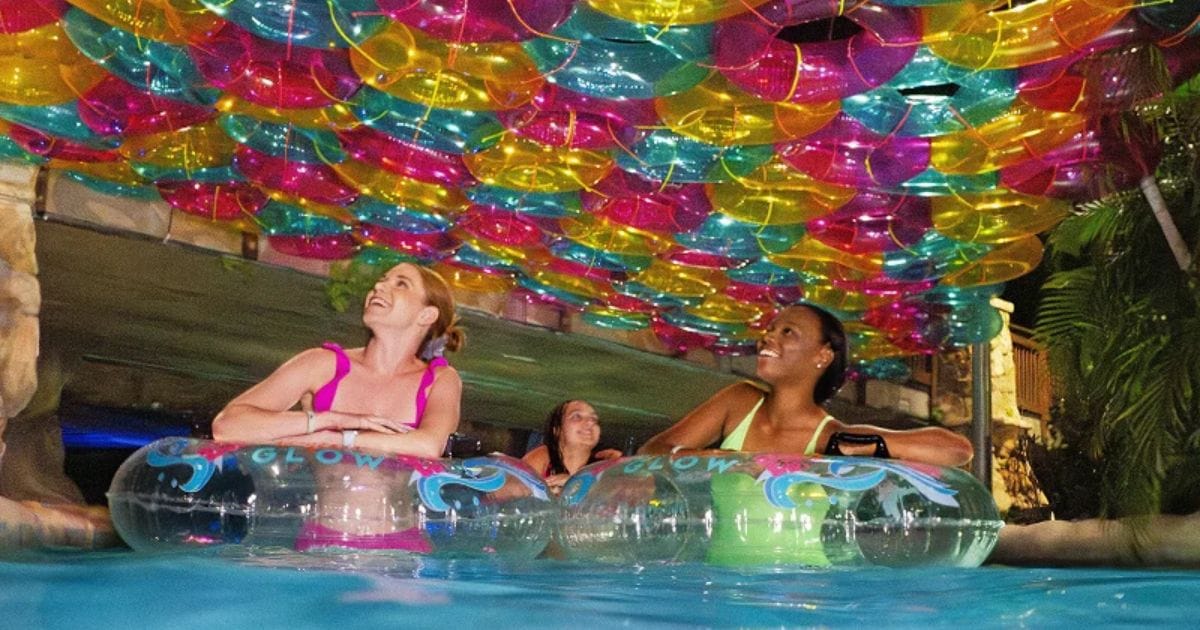 Aquatica Orlando September 2026 Pass Member Perks: Free Tickets & Dining Guide 6 Neon laser lights illuminating the wave pool at the Aquatica AquaGlow event