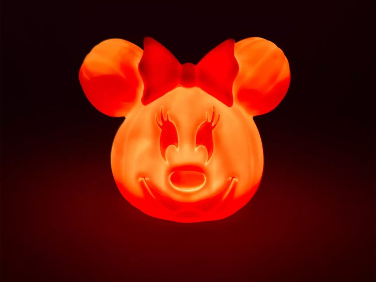 Glowing 2026 Minnie Mouse Light-Up Jack-o-Lantern in the dark, a Disney Visa Cardmember Exclusive.