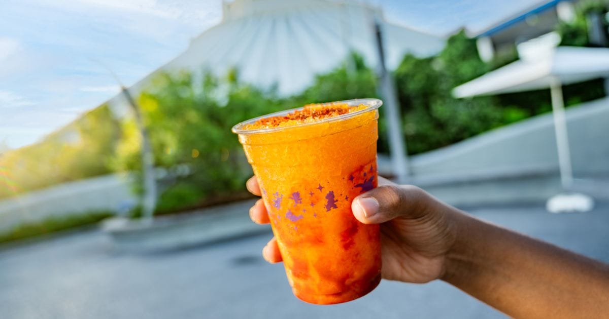 A tropical frozen mango beverage layered with chili seasoning and served cold at Disney's Magic Kingdom near Tomorrowland