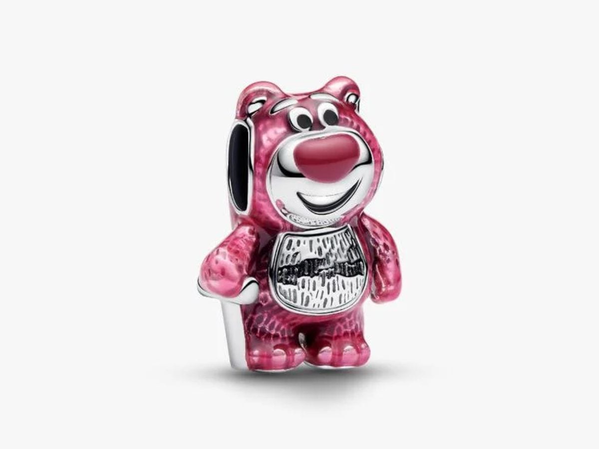 Close-up front view of the Disney x Pandora Lotso Bear charm featuring translucent pink enamel and sterling silver details.