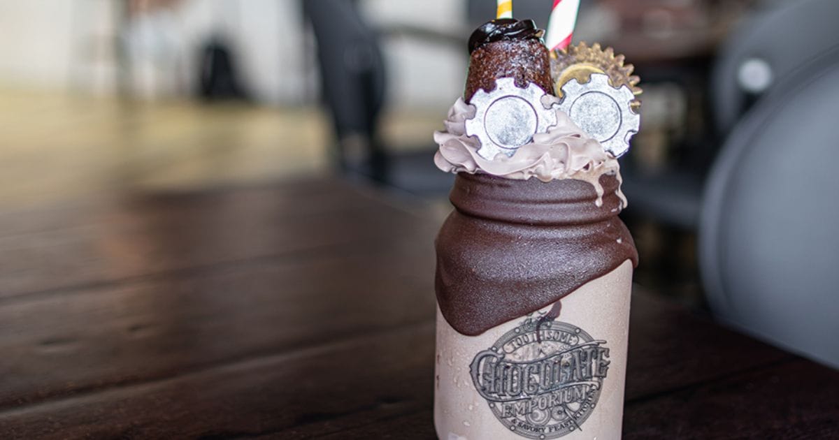 Cheers to 10 Years! Shake at Toothsome Chocolate Emporium served in a chocolate-dipped mason jar with chocolate gears on top