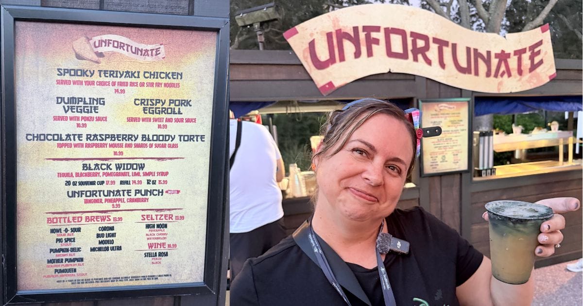 Menu board for the Unfortunate food booth and a person holding a specialty dark cocktail at SeaWorld Orlando Howl-O-Scream