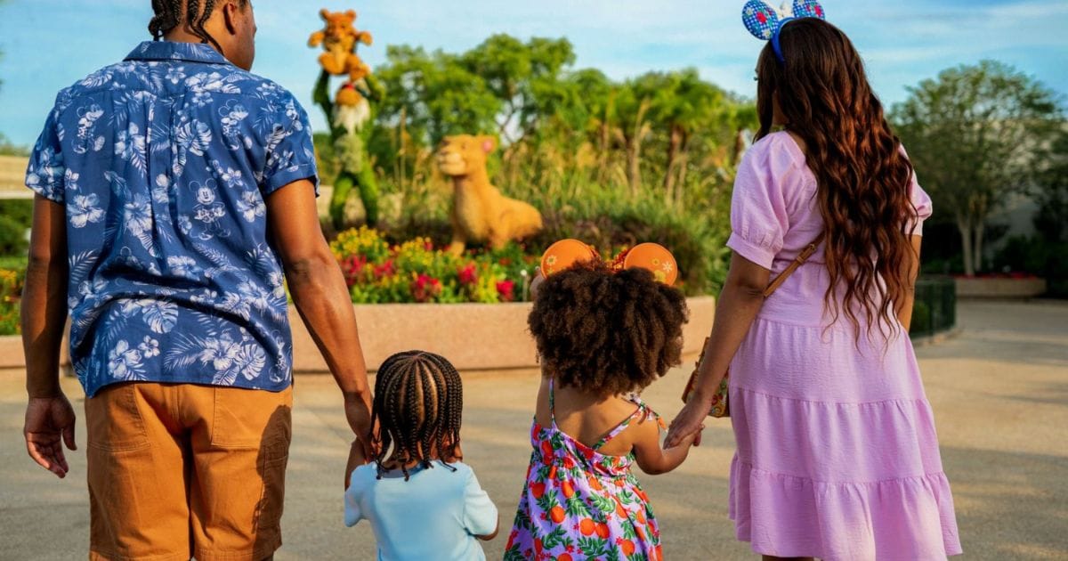 Disney character topiaries surrounded by spring flower beds during the EPCOT Flower and Garden Festival