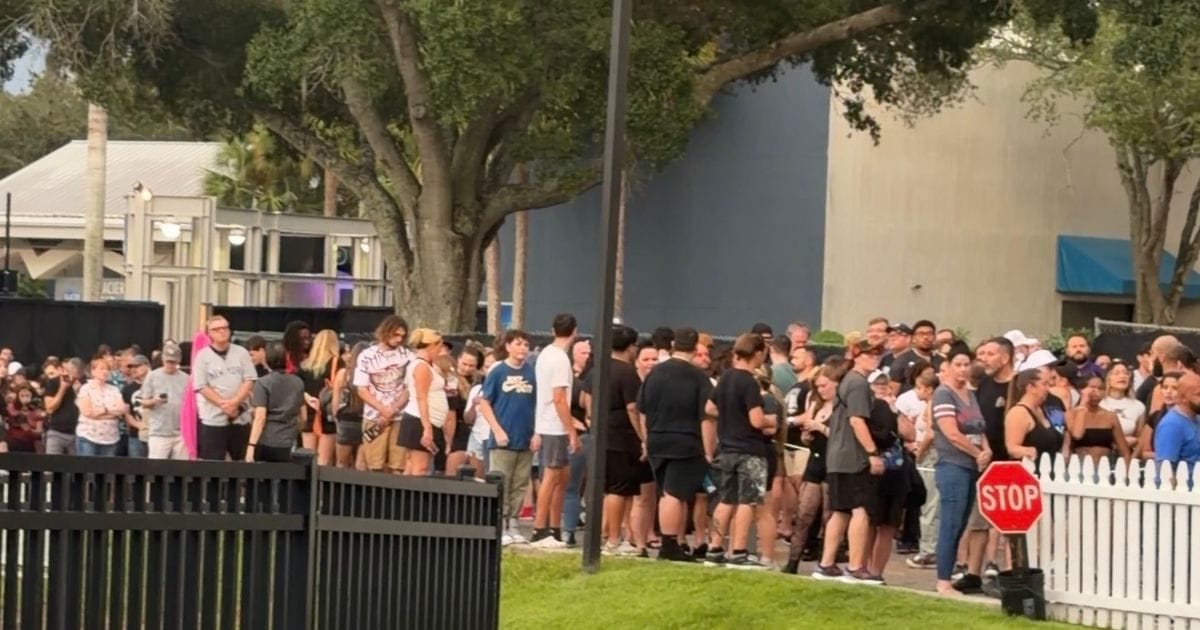 Large crowds of guests waiting in line to enter SeaWorld Orlando Howl-O-Scream Halloween event