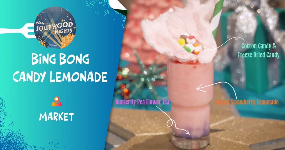 A purple frozen lemonade drink topped with pink cotton candy and Skittles