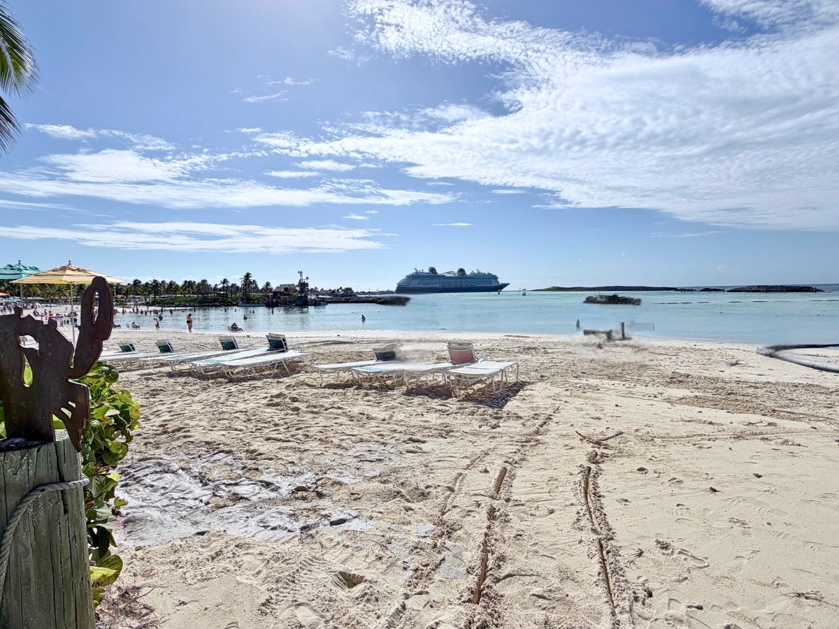 Industrial black dredging pipe floating offshore in the Castaway Cay lagoon