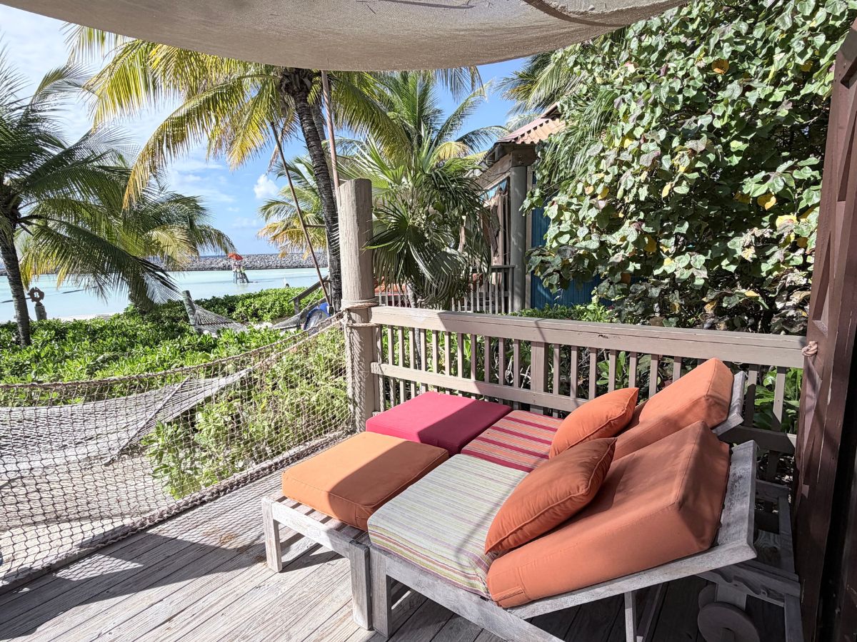 Private beach hammock strung between palm trees outside Cabana 7