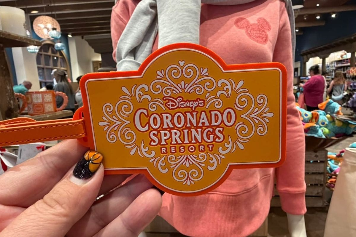 A luggage tag with the Coronado Springs resort logo and mosaic pattern