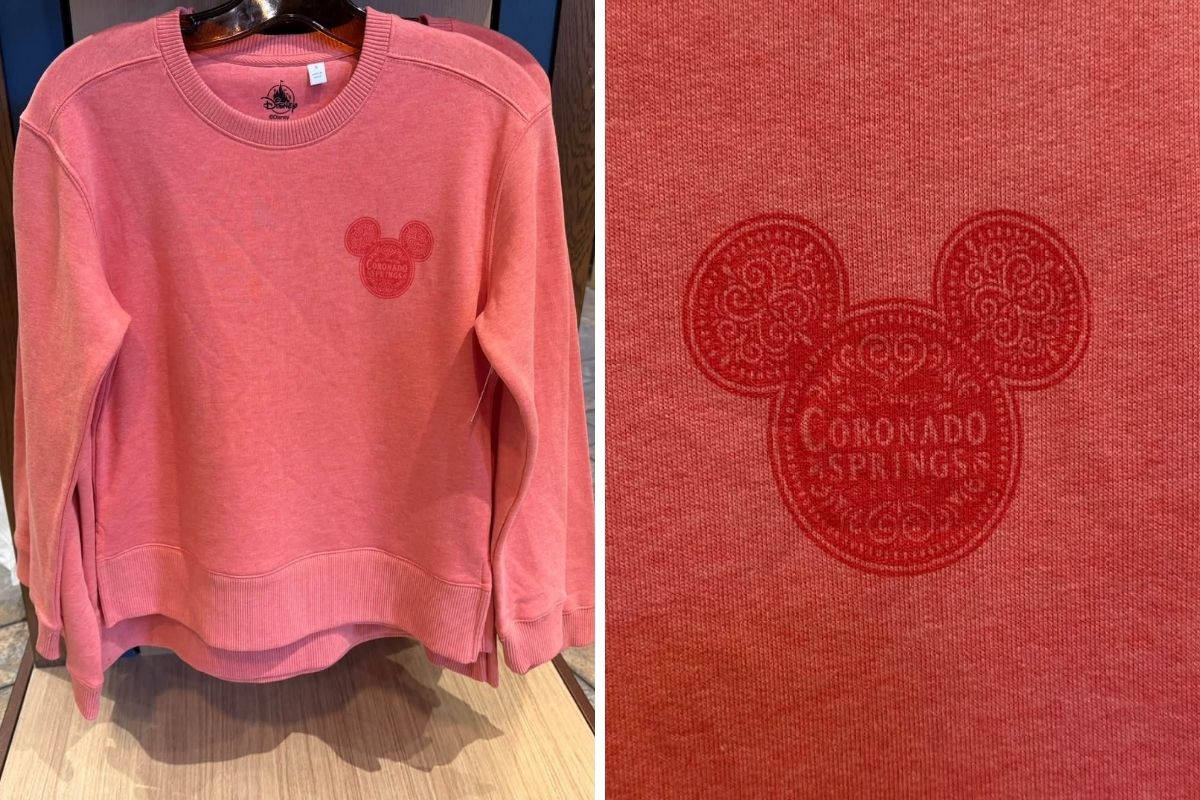 Pinkish-red pullover sweatshirt featuring the resort logo