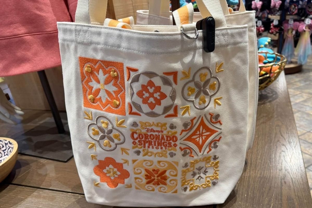 Canvas tote bag featuring embroidered orange and gold mosaic tile patterns for Coronado Springs