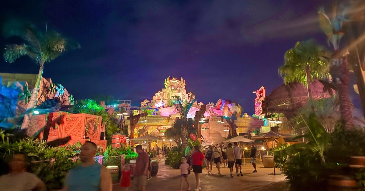The illuminated Golden Temple in Donkey Kong Country at Super Nintendo World during an Epic Universe after-hours event.