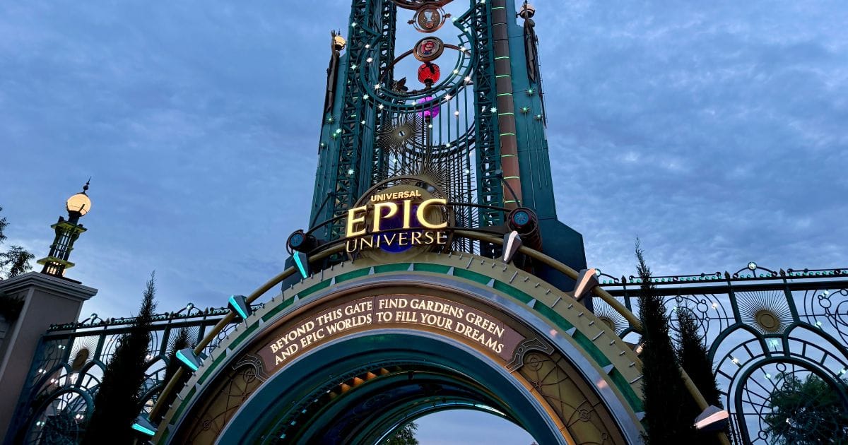 The Universal Epic Universe entrance portal illuminated against a twilight sky for an after-hours event.
