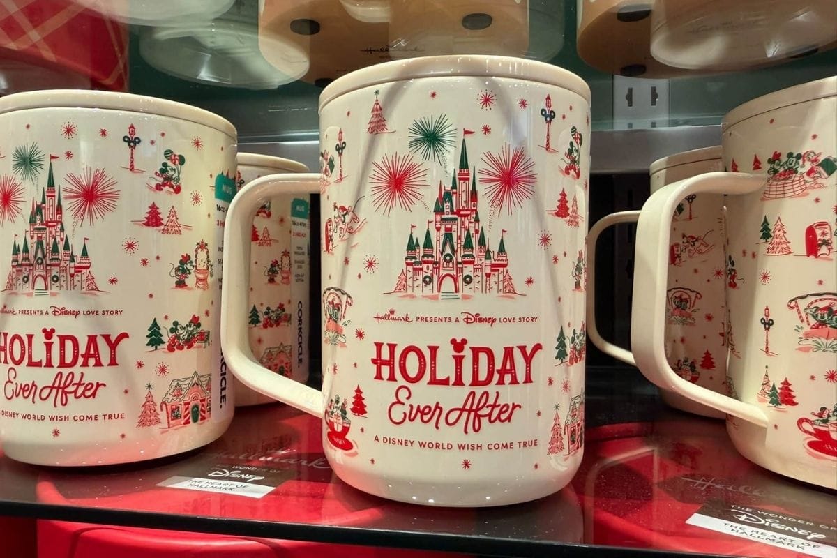 Hallmark and Disney Holiday Ever After 16-ounce Corkcicle stainless steel mug on a retail shelf