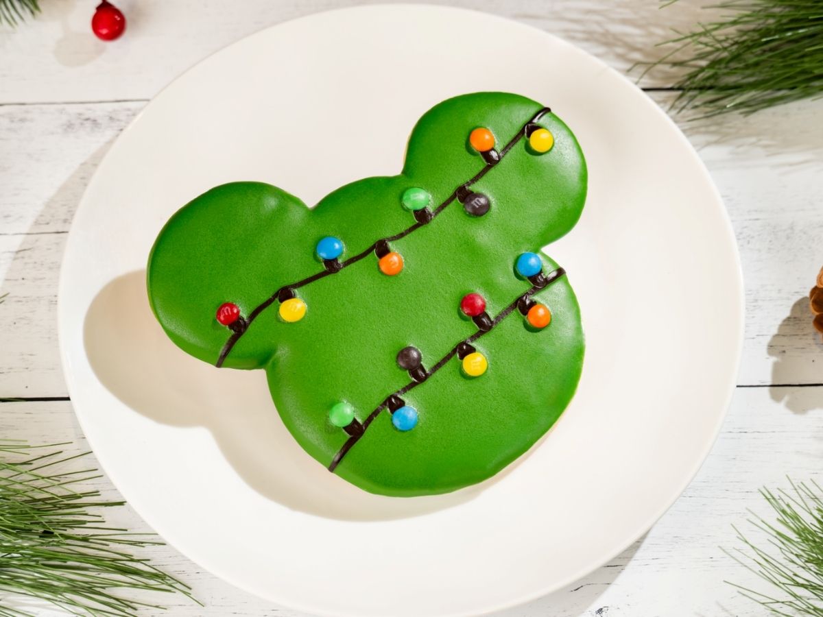 Large Mickey Holiday Sugar Cookie covered in white icing and sprinkles