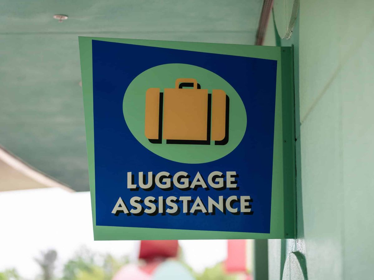 A guest dropping off bags at a Luggage Assistance station at a Walt Disney World resort