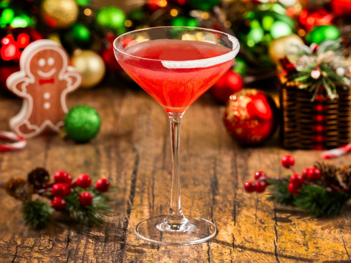A bright red Merry Berry Cosmopolitan cocktail served in a martini glass