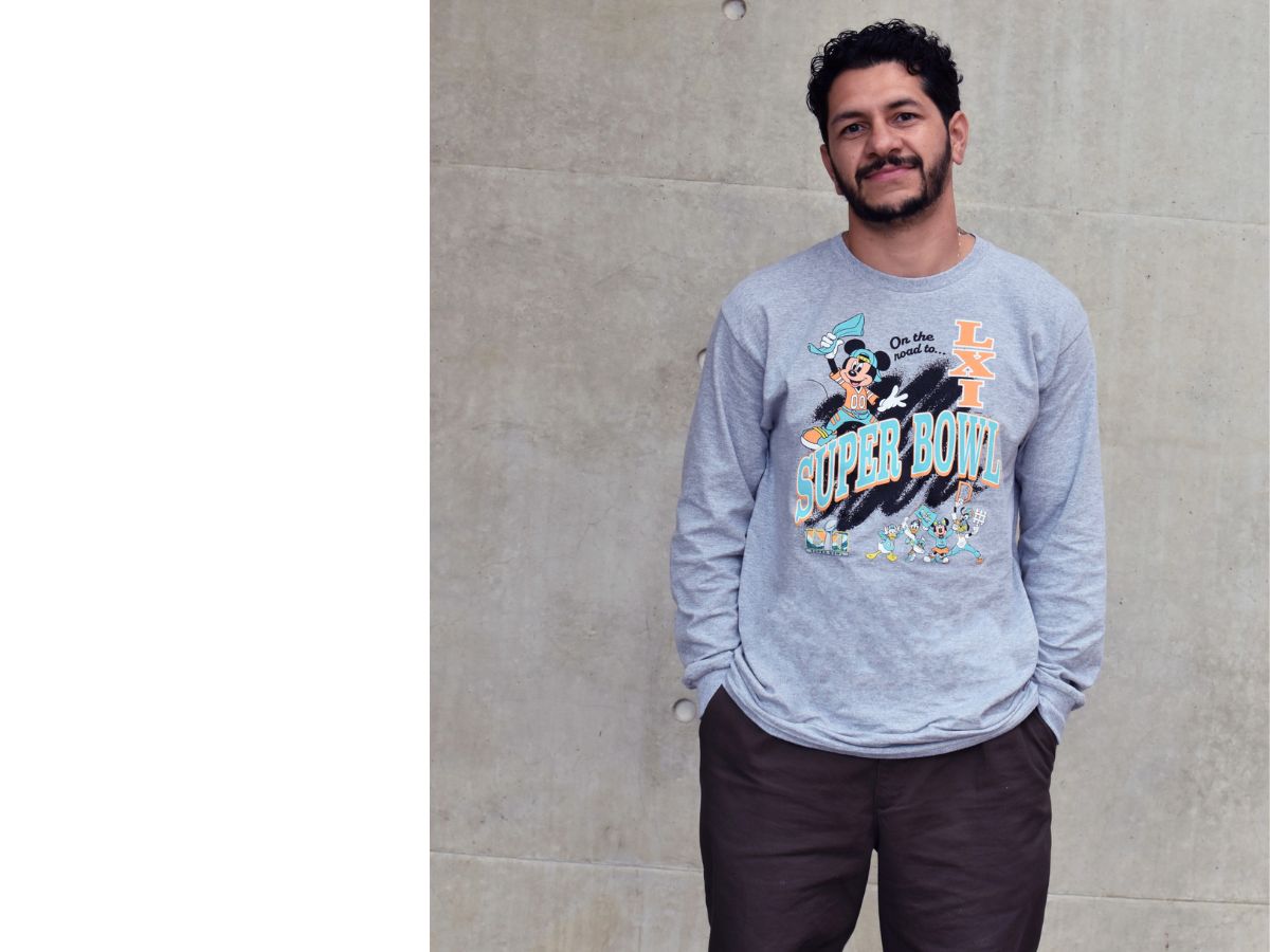 A model wearing the gray Champion sweatshirt with Mickey Mouse graphics