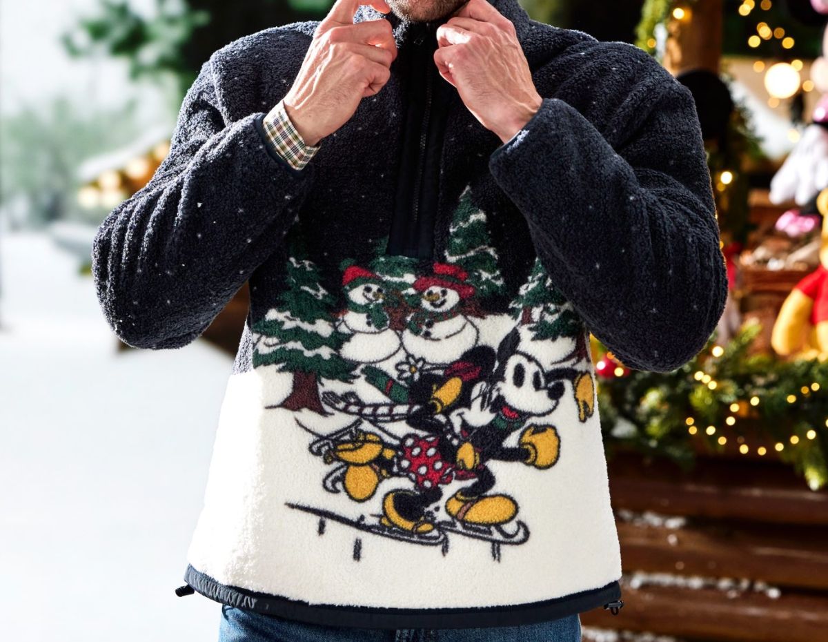 A person wearing the Mickey and Minnie Mouse Faux Shearling Holiday 1/4 Zip Jacket for Adults