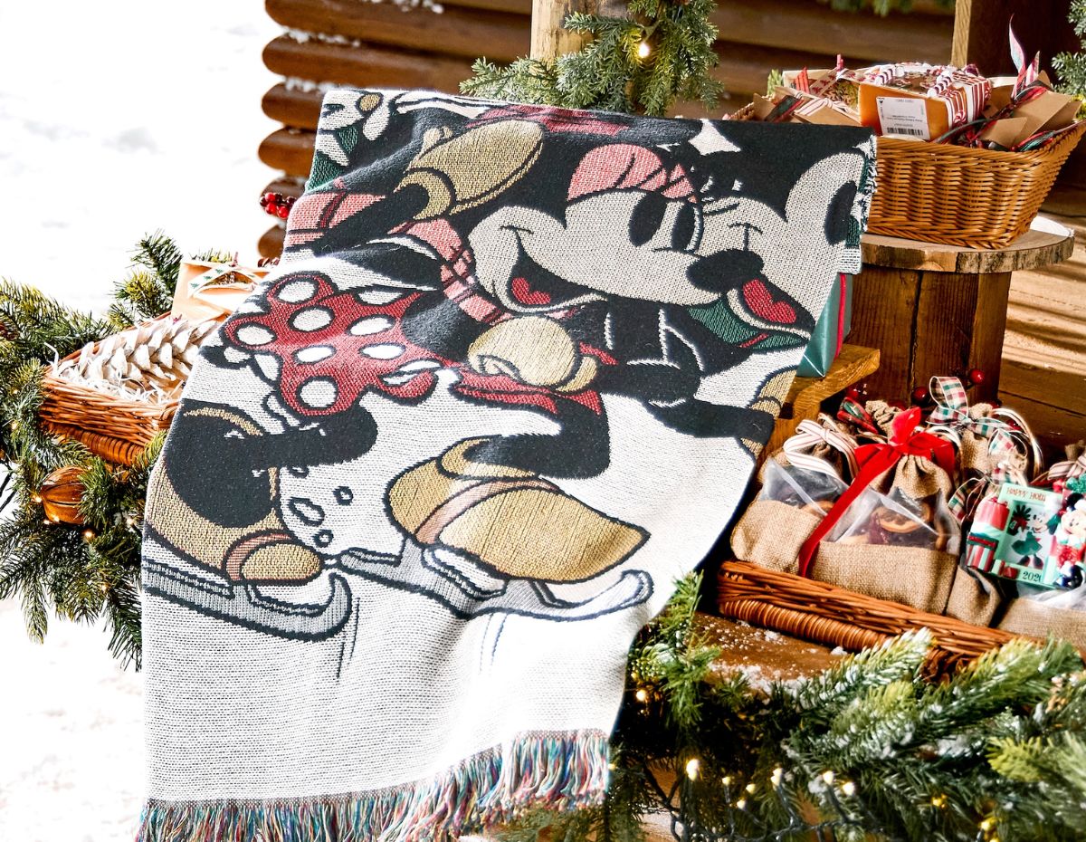 A folded Mickey and Minnie Mouse Holiday Throw Blanket