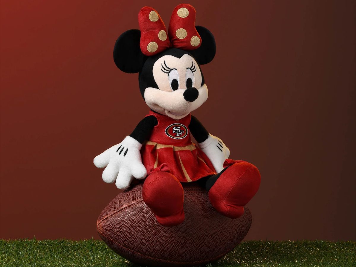 A 14-inch Minnie Mouse plush doll wearing a cheerleader outfit