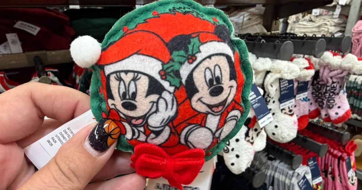 Classic Mickey and Minnie Mouse faces inside holly wreaths on tartan fabric