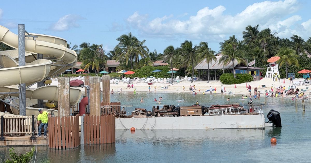 Wide perspective of the quiet Castaway Cay shoreline with Pelican Plunge resting offline