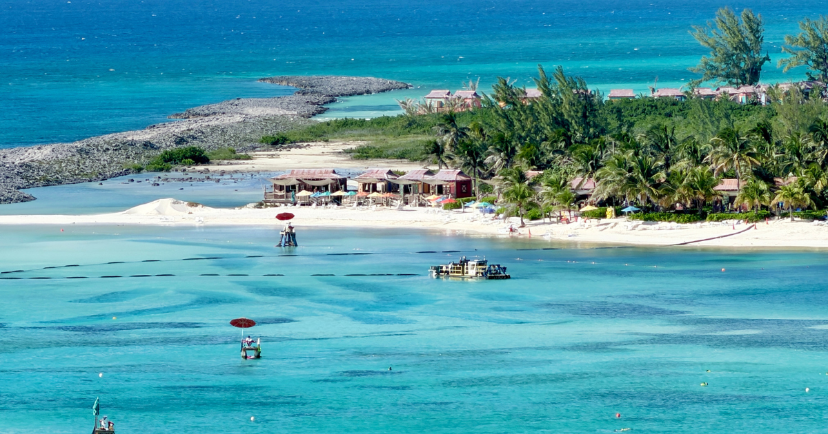 Murky brown lagoon water and exposed dredge piping along Castaway Cay Family Beach