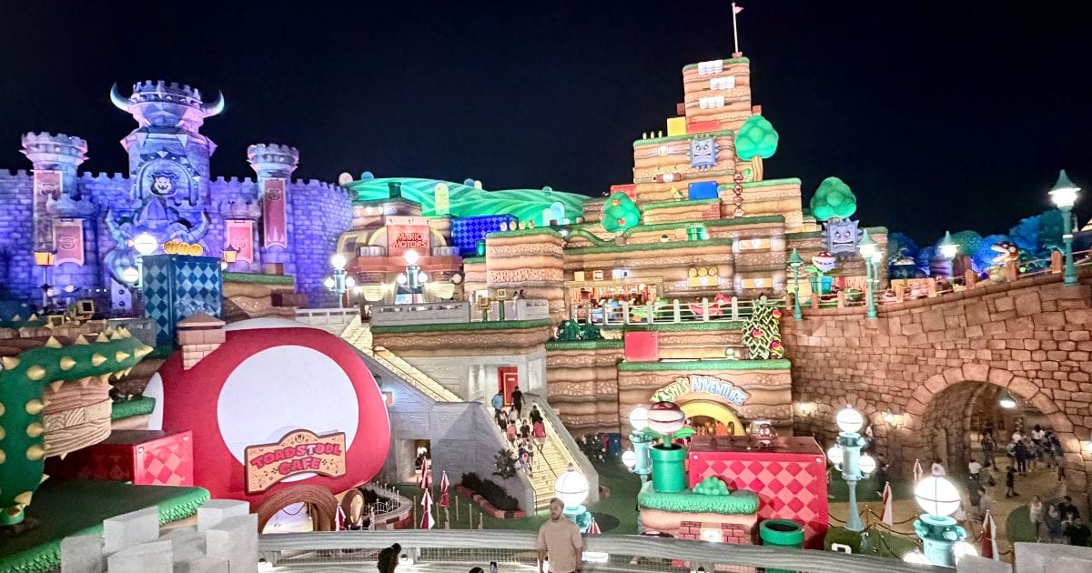 Super Nintendo World illuminated at night with minimal crowds during an after-hours event at Universal Epic Universe.