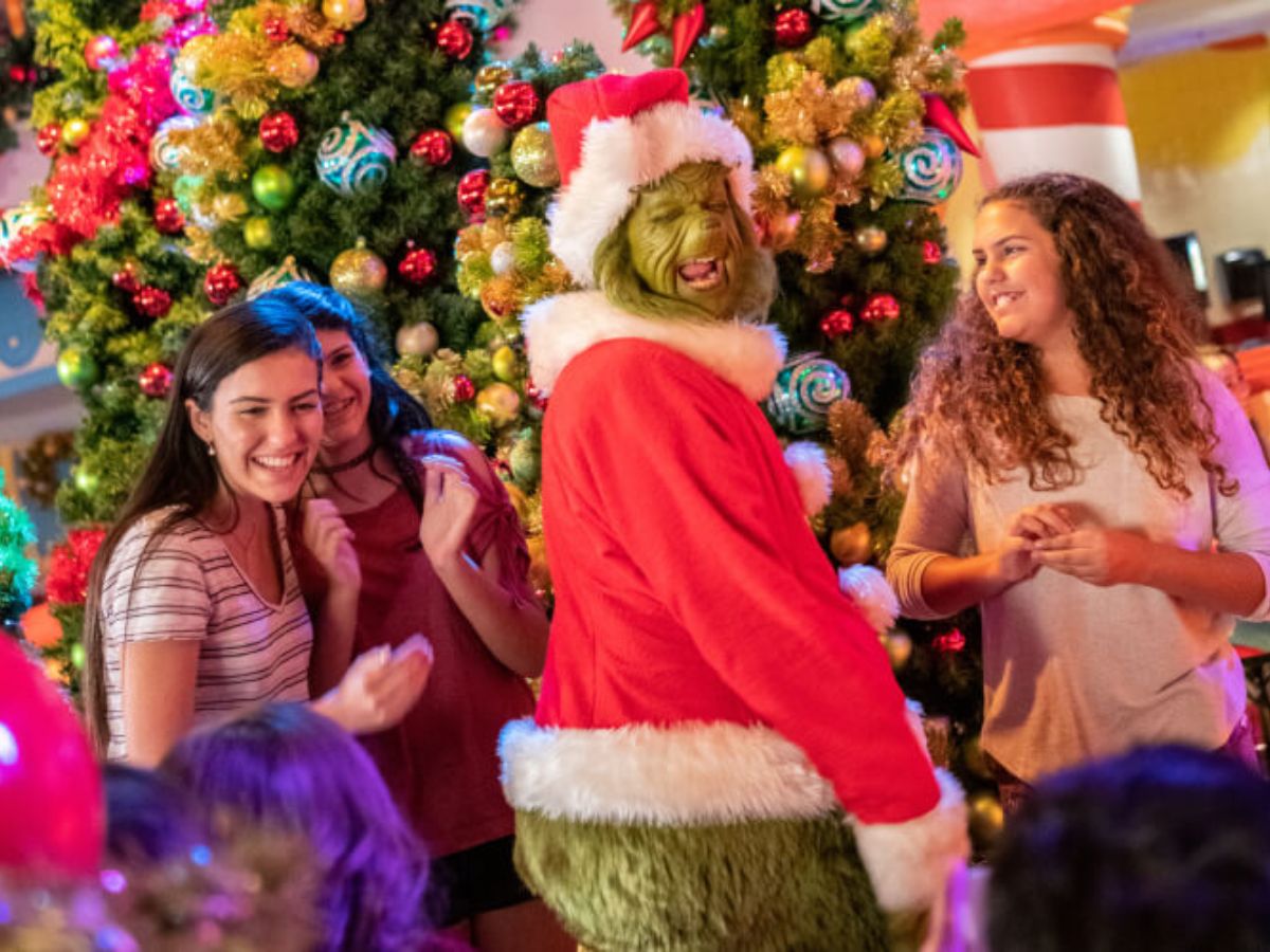 The Grinch posing with guests at a character breakfast table