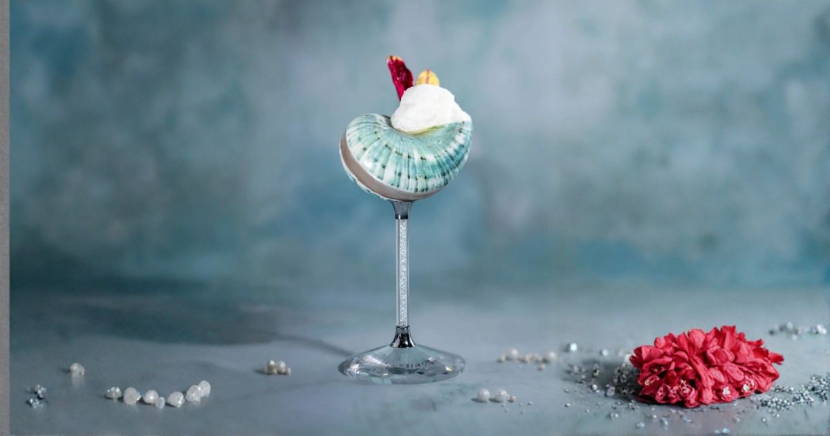 The Under the Seaweed cocktail in a glass on the Disney Believe