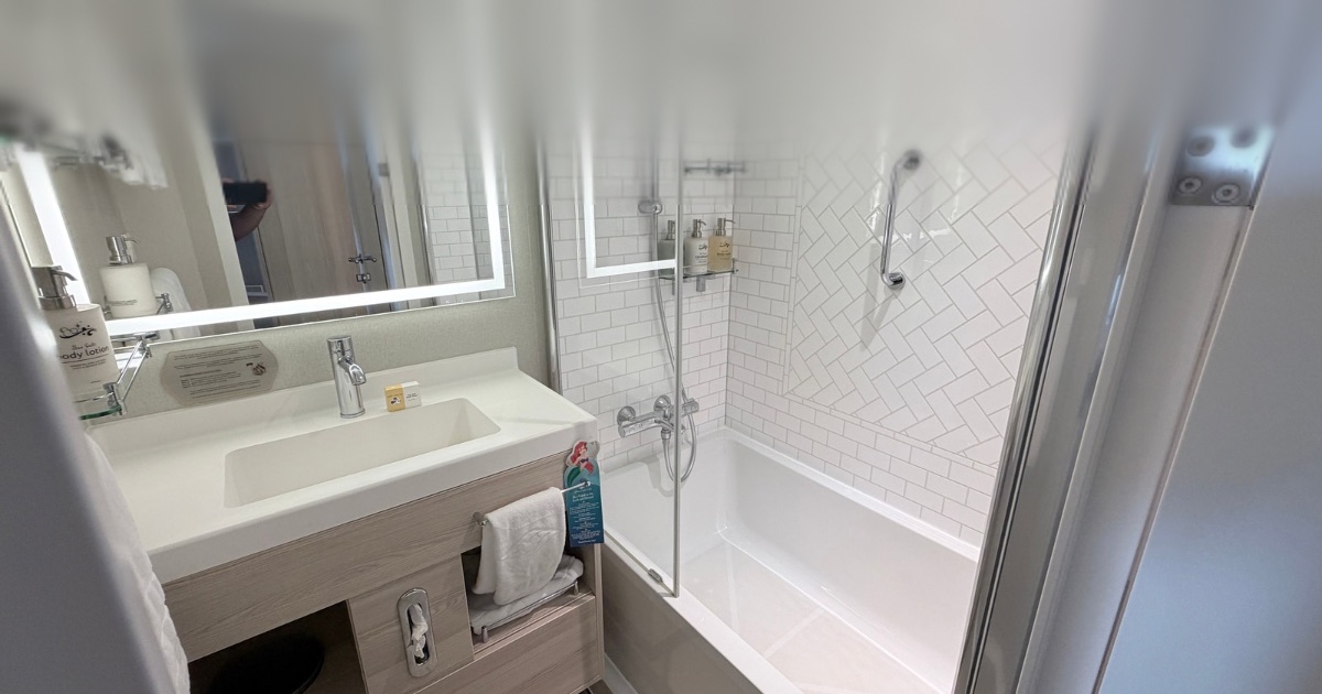 Flip-over couch and bunk area in Disney Treasure Stateroom 10550